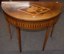19th century mahogany fold-top card table of demi-lune form, the lid inlaid with a central panel