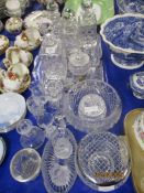 VARIOUS GLASS DECANTERS ON TRAYS AND OTHER GLASS WARES INCLUDING CANDLESTICKS AND SMALL VASES