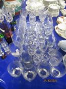 LARGE QUANTITY OF GLASS WARES INCLUDING WINE GLASSES, TUMBLERS AND LIQUEUR GLASSES