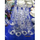 LARGE QUANTITY OF GLASS WARES INCLUDING WINE GLASSES, TUMBLERS AND LIQUEUR GLASSES