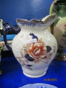 ENGLISH POTTERY LARGE JUG WITH FLORAL DECORATION AND BLUE HANDLE