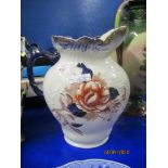 ENGLISH POTTERY LARGE JUG WITH FLORAL DECORATION AND BLUE HANDLE