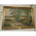 OIL ON PANEL OF A LANDSCAPE IN GILT FRAME