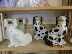 GROUP OF STAFFORDSHIRE POODLES, TWO WITH A WHITE AND GILT DESIGN, TWO WITH A SPONGED BLACK AND