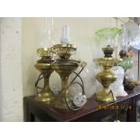 GROUP OF THREE METAL LAMPS, TWO WITH GLASS FUNNELS