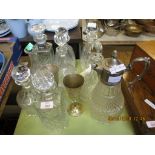 GROUP OF CUT GLASS DECANTERS AND PLATED CLARET JUG INCLUDING SHIPS DECANTER AND TWO PLATED GOBLETS