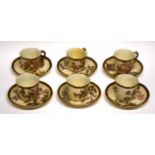 Group of six Worcester cups and saucers, the blush ground body decorated in flowers with gilt