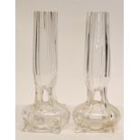 Pair of early 20th century glass bud vases raised on four stub feet with reeded glass, 20cm high (2)