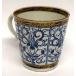 18th century Worcester coffee cup with shaped handle, decorated in underglaze blue with the music