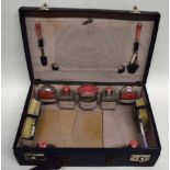 Art Deco travelling case with fitted interior, the top initialled L.I.R., contents include compacts,