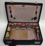 Art Deco travelling case with fitted interior, the top initialled L.I.R., contents include compacts,