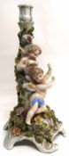 Continental porcelain candlestick, the main decoration with trailing flowers and two cherubs, 33cm