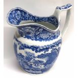 Early 19th century English Pottery jug with a flow blue design of thatched cottage below floral