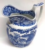 Early 19th century English Pottery jug with a flow blue design of thatched cottage below floral