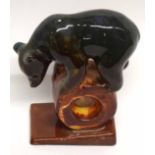 Russian pottery bear standing on a circular device