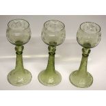 Group of three Bohemian style wine glasses with engraved floral decoration above a knopped stem (3)