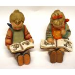 Two Goebbels figures of seated children reading books