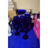 GROUP OF BLUE GLASS WINE GLASSES AND GLASS TAZZA