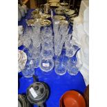 GROUP OF CUT GLASS WARES INCLUDING TUMBLERS AND WINE GLASSES AND LIQUEUR GLASSES