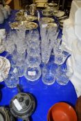 GROUP OF CUT GLASS WARES INCLUDING TUMBLERS AND WINE GLASSES AND LIQUEUR GLASSES