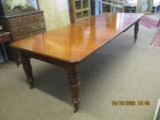 Late 19th century mahogany wind-out extending dining table with canted corners raised on ring turned