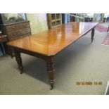 Late 19th century mahogany wind-out extending dining table with canted corners raised on ring turned