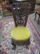 Carved mahogany bedroom chair with scrolled splat back
