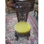 Carved mahogany bedroom chair with scrolled splat back