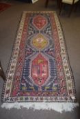 Caucasian large wool runner, double gull border, central panel of three interlinked lozenges with