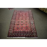 Modern Caucasian carpet with multi-gull border, central panel of lozenges, mainly red field, 181 x