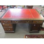 Late 19th/early 20th century mahogany partner~s desk with gilt tooled red inset, the two pedestals
