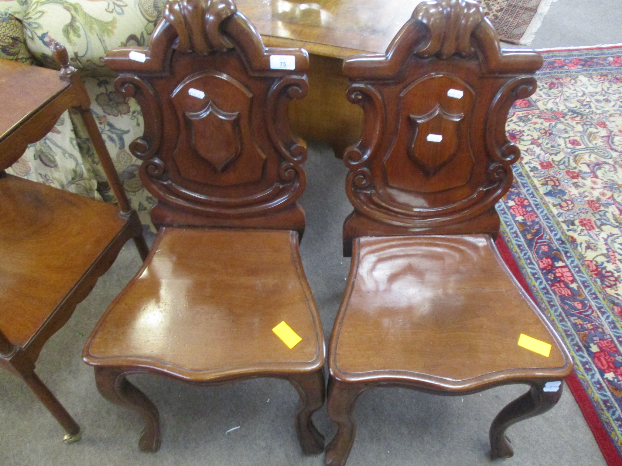 Pair of Victorian mahogany hall chairs with C-scroll moulded arch backs solid seats and cabriole