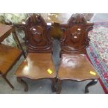 Pair of Victorian mahogany hall chairs with C-scroll moulded arch backs solid seats and cabriole
