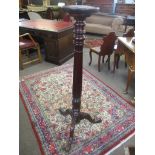 Mahogany torchere stand with tripod base, 131cm high