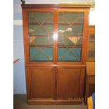 Mahogany bookcase cabinet with dentil corners over astragal glazed doors and cupboard base, 223cm