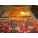 Edwardian mahogany inlaid |envelope| fold-top card table with single frieze drawer raised on