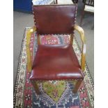 Oak carver chair red upholstered back and seat, the four plain supports joined by an H stretcher