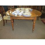 Large oak drop leaf dining table raised on ring turned supports with casters, 157cm wide