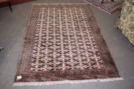 Modern Caucasian carpet, multi-gull border, central panel of geometric designs, mainly brown field