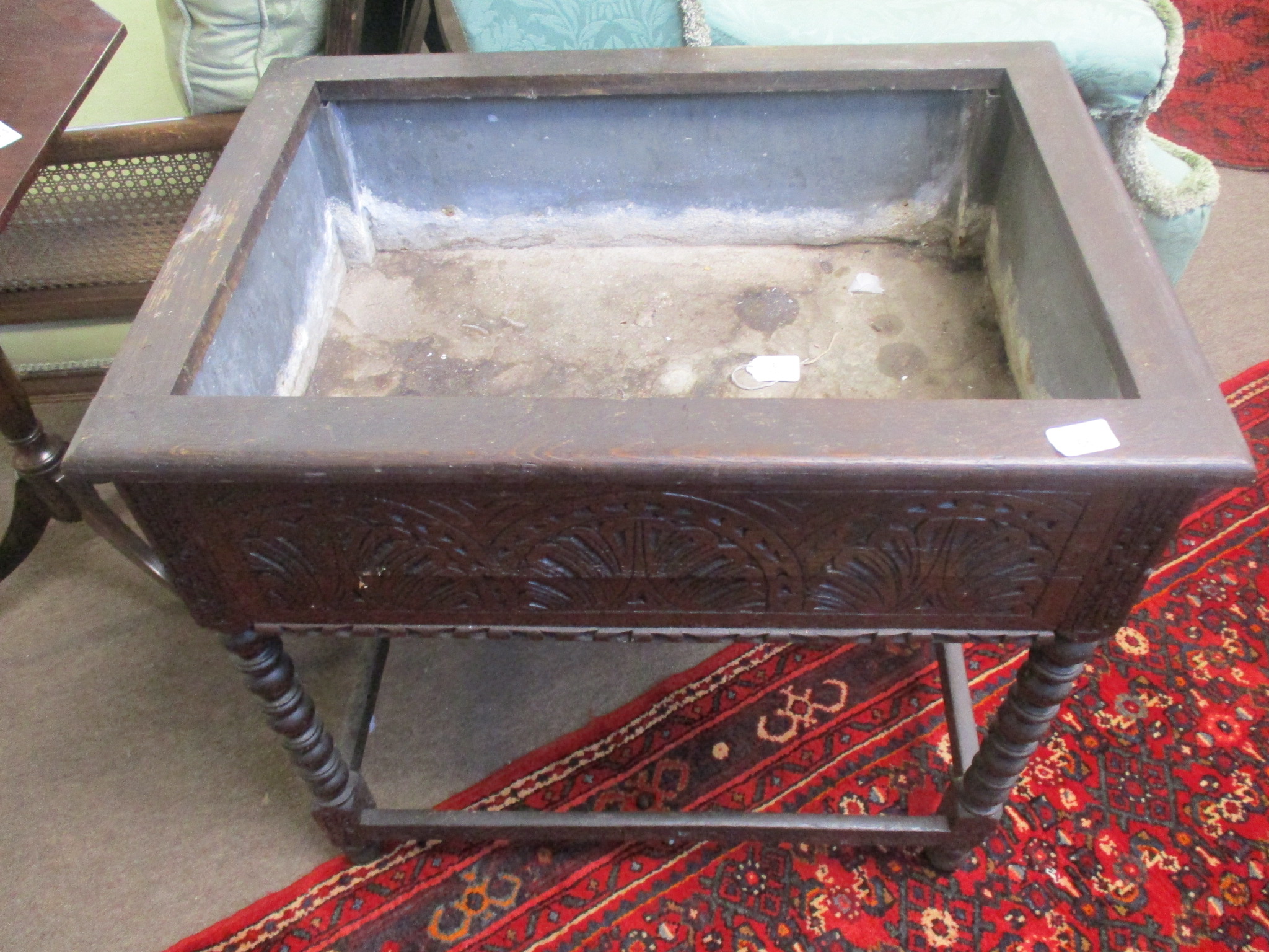 Oak planter of rectangular form with zinc lined interior, carved frieze on bobbin turned supports