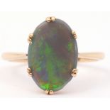 Opal doublet ring, the oval shaped opal is multi-clawed set in a plain polished mount, stamped 18ct,