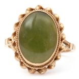 Late 20th century 9ct gold and jade ring, the oval shaped jade panel bezel set in a rope twist