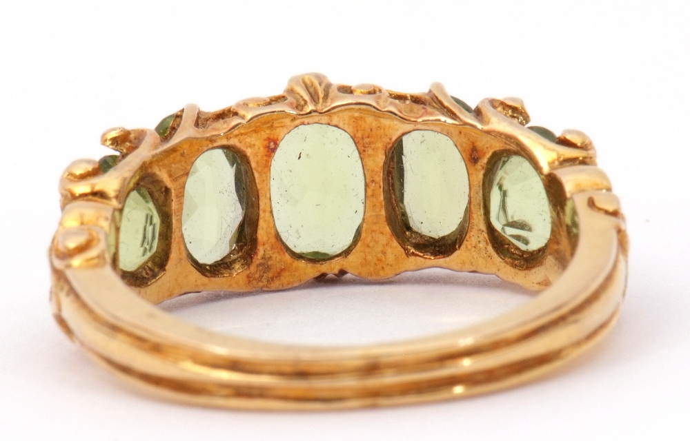 9ct gold five stone peridot ring, featuring five graduated oval cut peridots, claw set in carved - Image 3 of 8