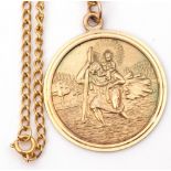 9ct gold large circular St Christopher, 32mm diam, London 1972, suspended from an oval link chain