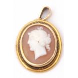 Antique carved shell cameo oval pendant depicting a classical lady, framed in a yellow metal mount