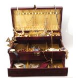 Brown leatherette folding jewel box to include various costume items, rings, brooches, necklaces,