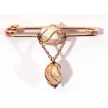 Baroque pearl pin brooch centring a wire work set baroque pearl with similar set dropper below,