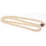 Cultured pearl necklace, a single row of uniform beads, 6mm diam, to a white 9ct small ruby set