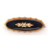 15ct stamped onyx, diamond and seed pearl mourning brooch, the elongated oval onyx panel applied