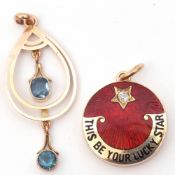 Mixed Lot: yellow metal circular shaped locket, the front with a red enamel detail with the black